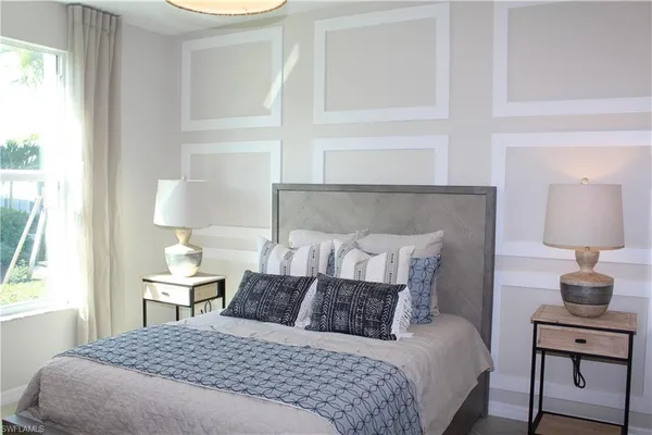 a bedroom with a bed and a lamp on table