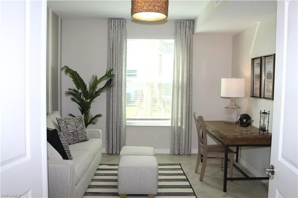 a bedroom with furniture and a window