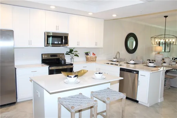a kitchen with a sink cabinets and wooden floor