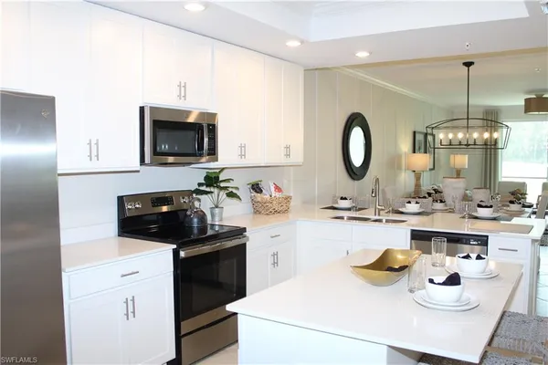 a kitchen with sink a stove and cabinets