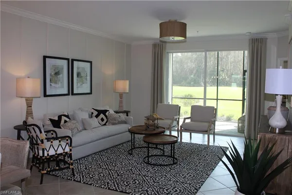 a living room with furniture a table and a large window