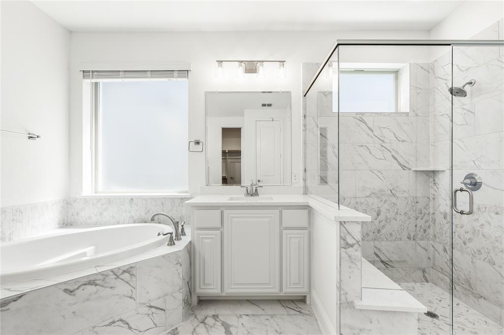 1145 Hitching Post Way Oak Point, TX 75068 - Photo 27 of 39 a bathroom with a bathtub and a sink