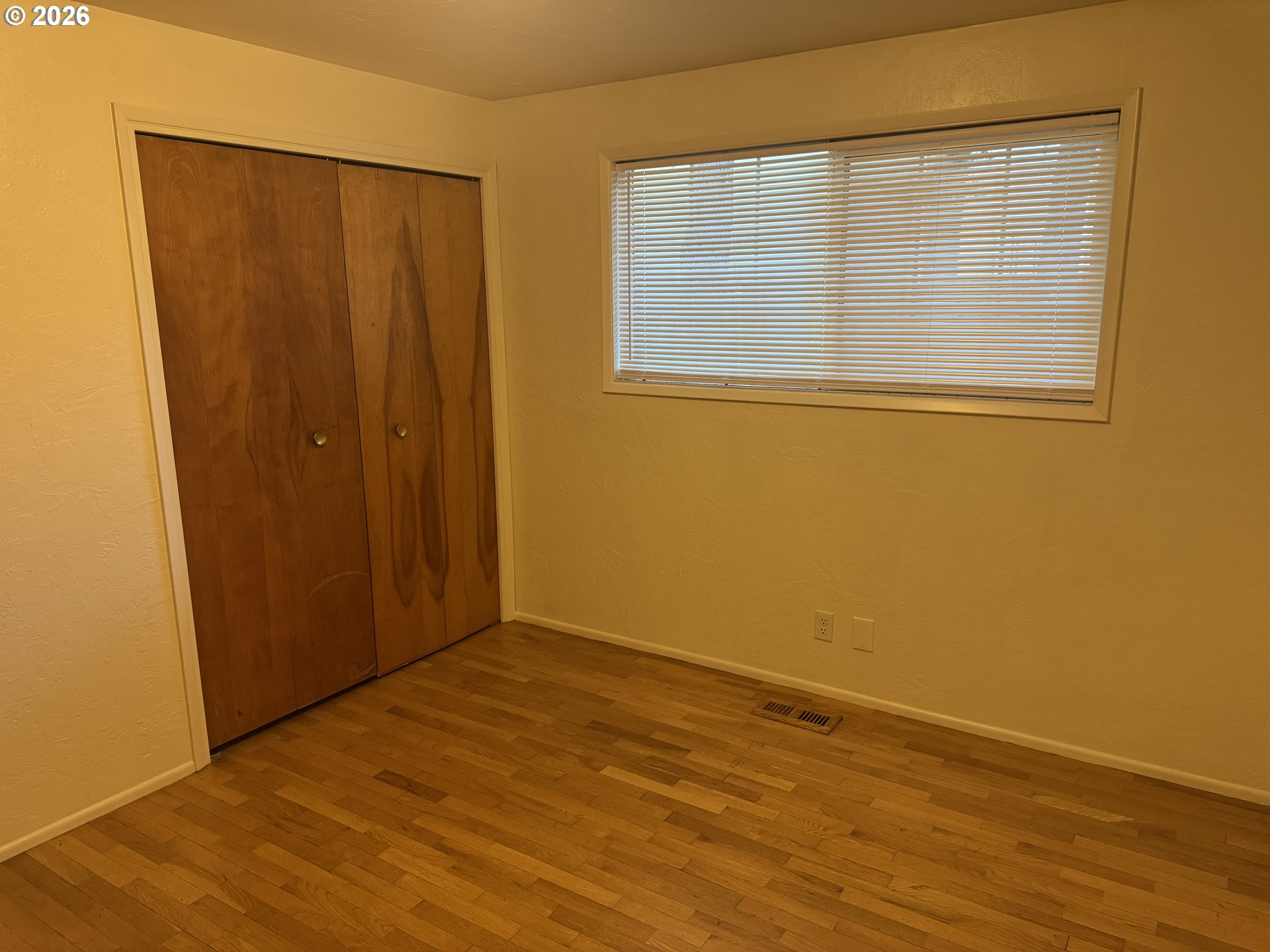 260 Susan Street Eugene, OR 97404 - Photo 22 of 33 an empty room with wooden floor and a window