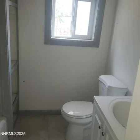 a white toilet sitting next to a bathroom sink