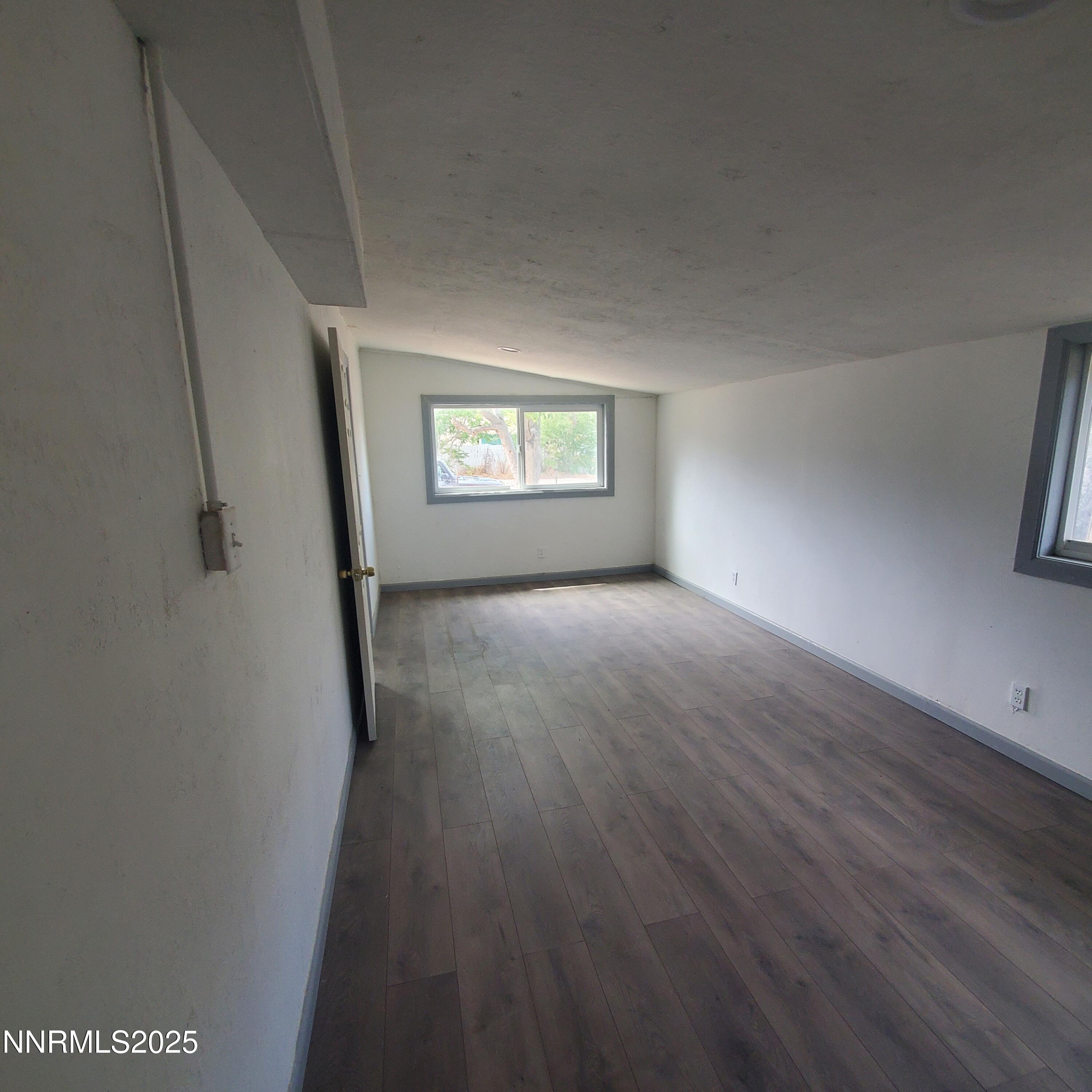 742 D Street Hawthorne, NV 89415 - Photo 4 of 13 an empty room with wooden floor and windows