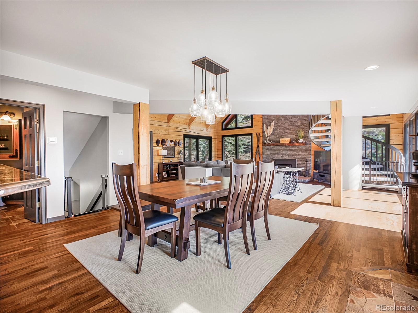 24 Pine Valley Road Evergreen, CO 80439 - Photo 12 of 50 a view of a dining room with furniture a rug and wooden floor