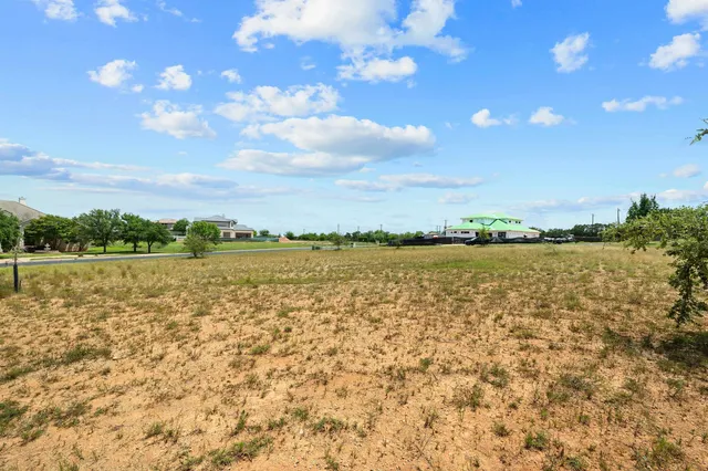a view of a lake with houses in the back