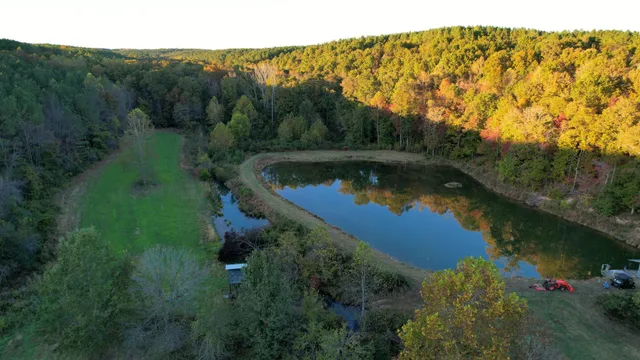 an aerial view of a house with a yard and lake view