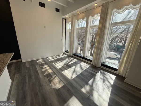 a view of an empty room and wooden floor