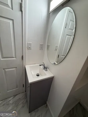 a bathroom with a sink a mirror and vanity