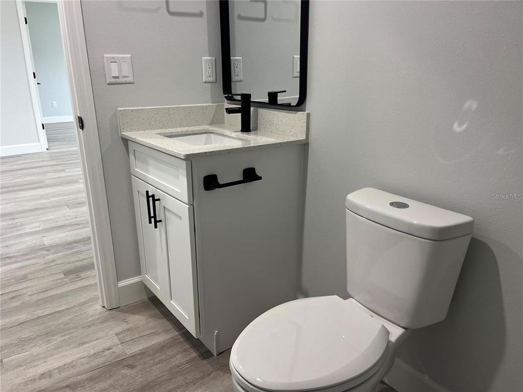 7209 Ancha Street Sebring, FL 33872 - Photo 10 of 18 a white toilet sitting next to a bathroom sink