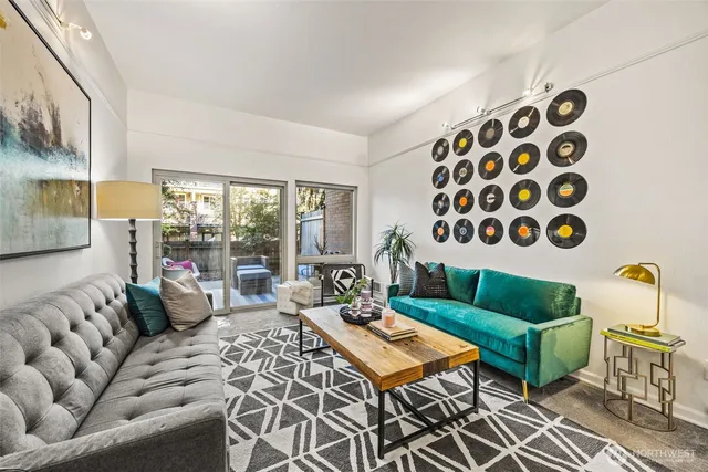 a living room with furniture and a floor to ceiling window