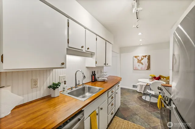a kitchen that has a sink and a stove in it