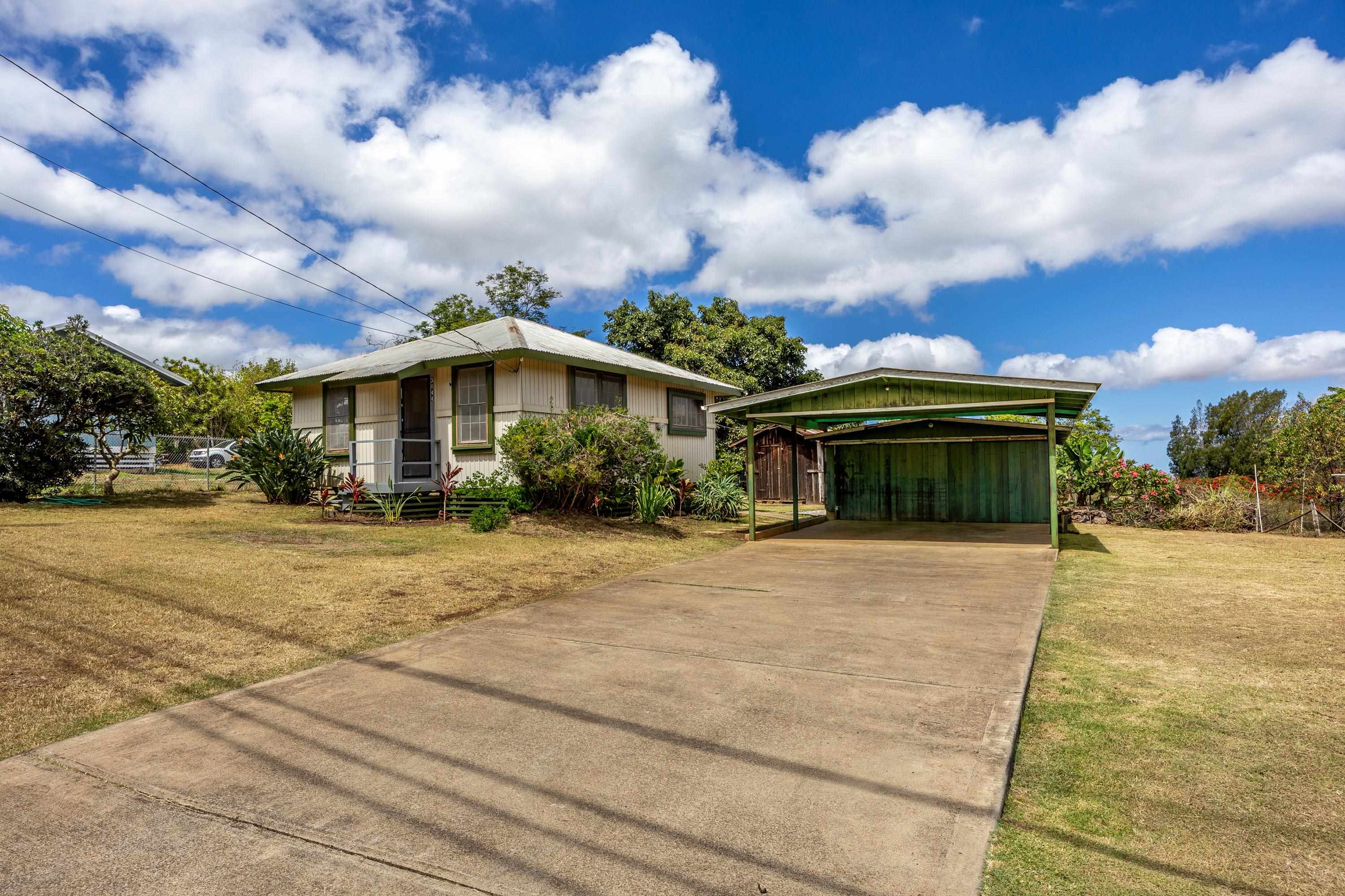 a front view of a house with a yard and trees