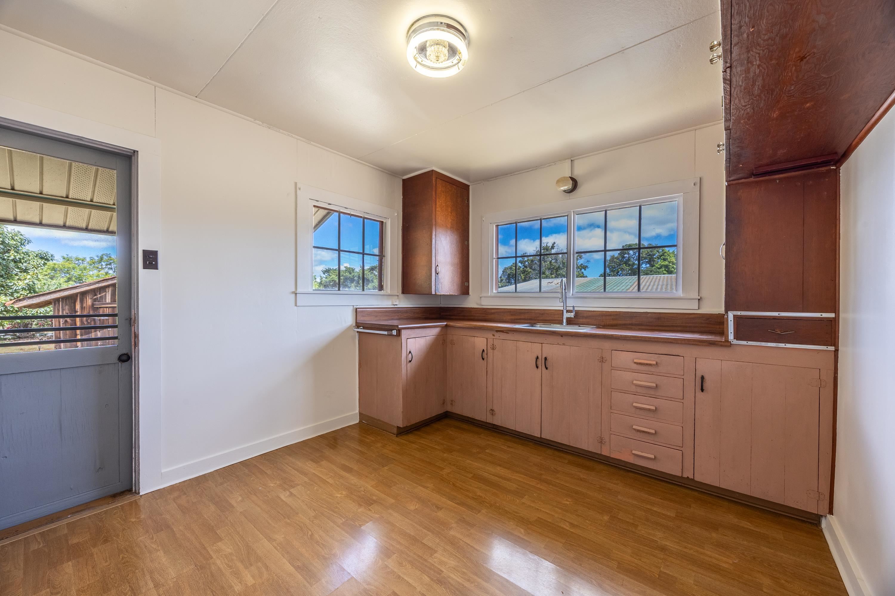 3044 Lower Kula Road Kula, HI 96790 - Photo 3 of 44 a large kitchen with a lot of counter space and wooden floor