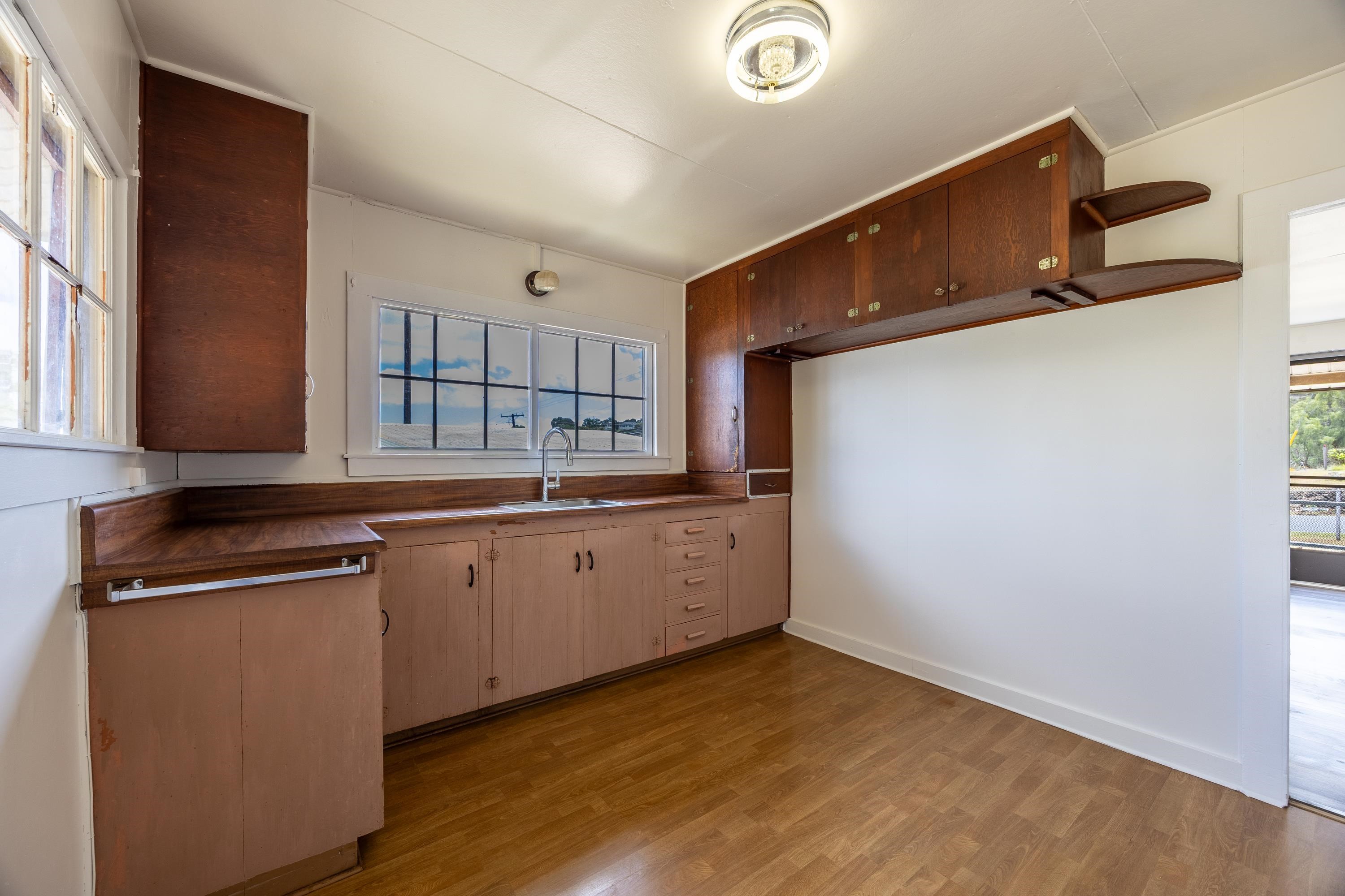 3044 Lower Kula Road Kula, HI 96790 - Photo 4 of 44 a kitchen with granite countertop a sink and cabinets