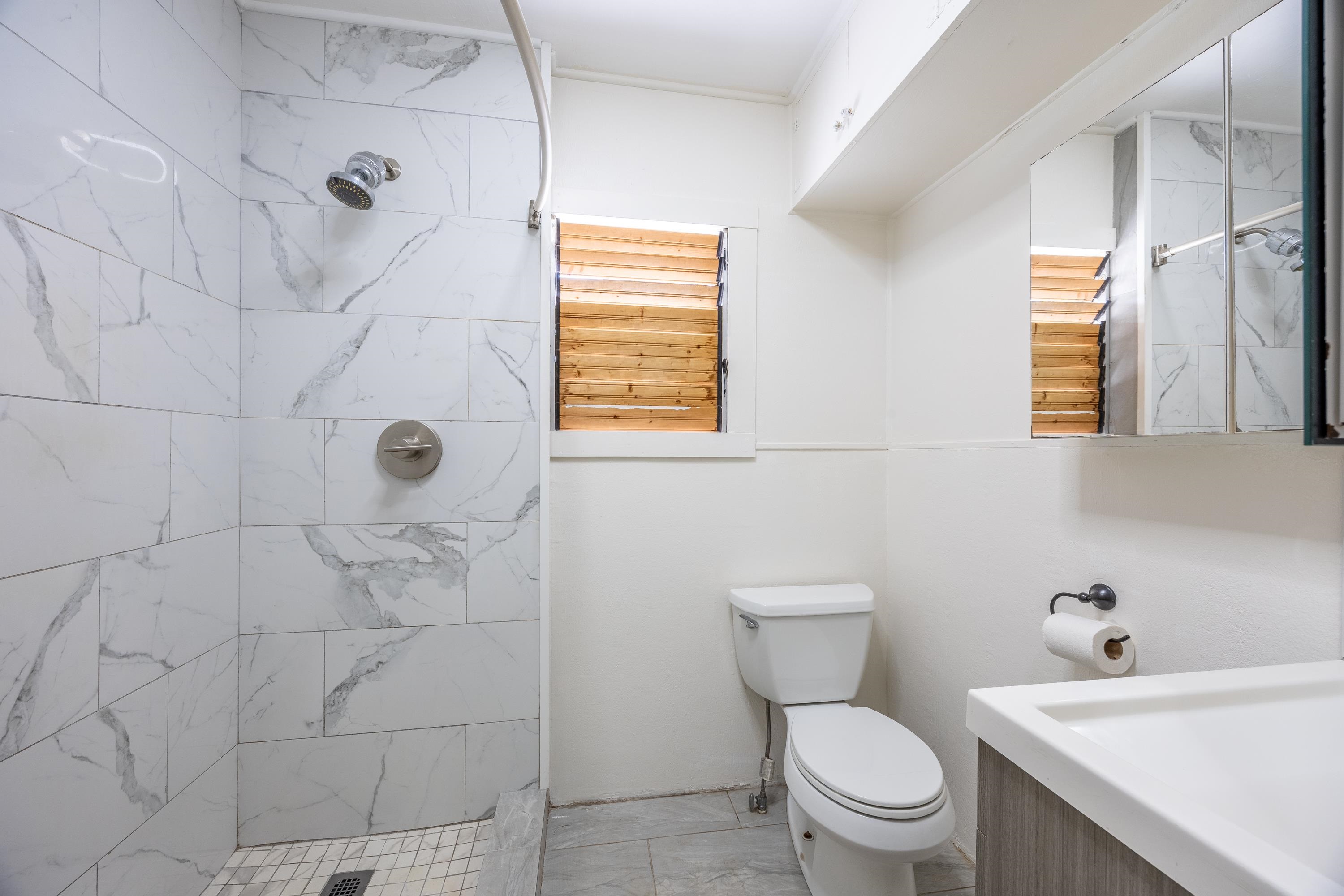 3044 Lower Kula Road Kula, HI 96790 - Photo 43 of 44 a white toilet sitting next to a bathroom sink