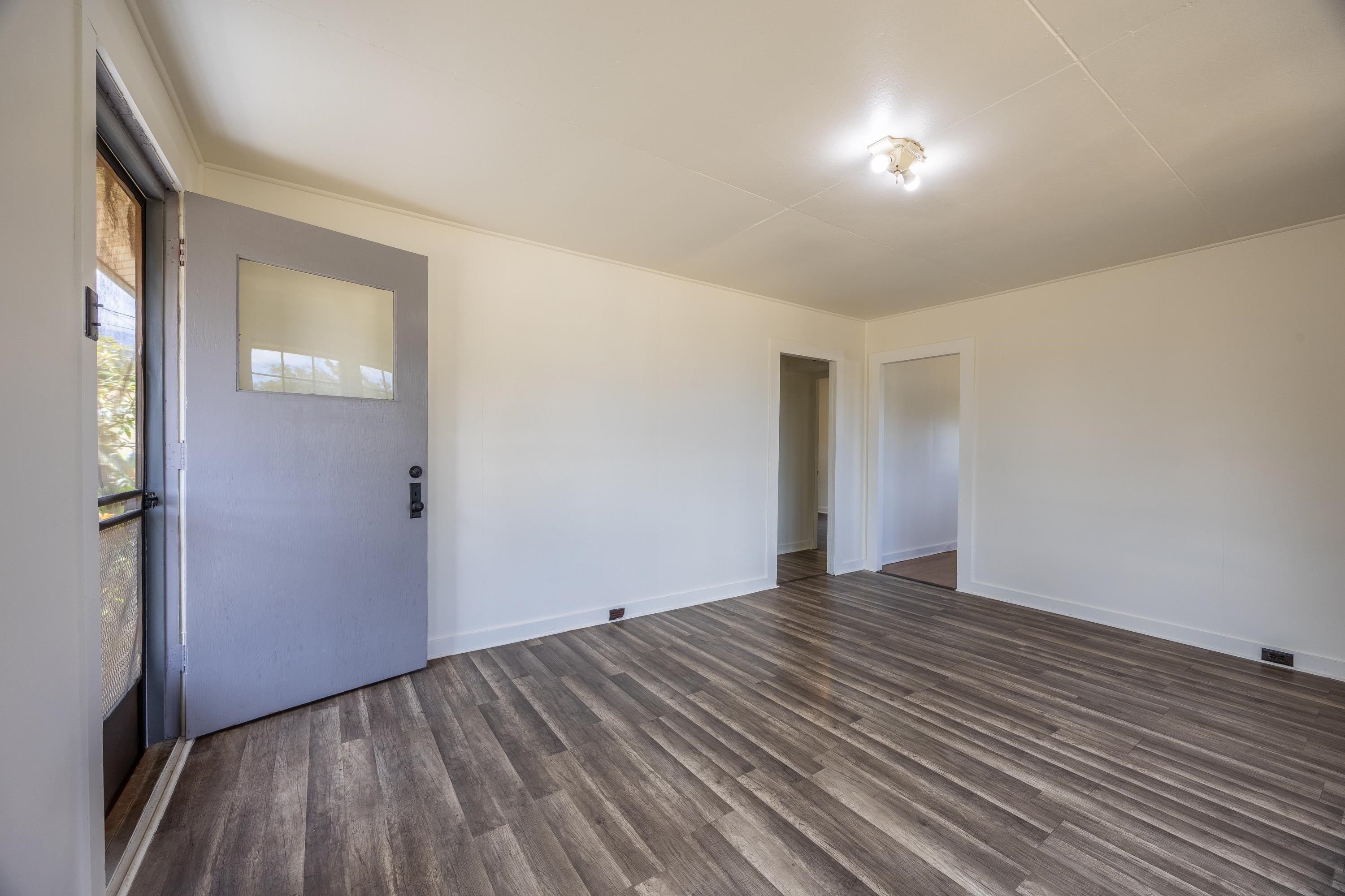 3044 Lower Kula Road Kula, HI 96790 - Photo 5 of 44 a view of an empty room with wooden floor and a window