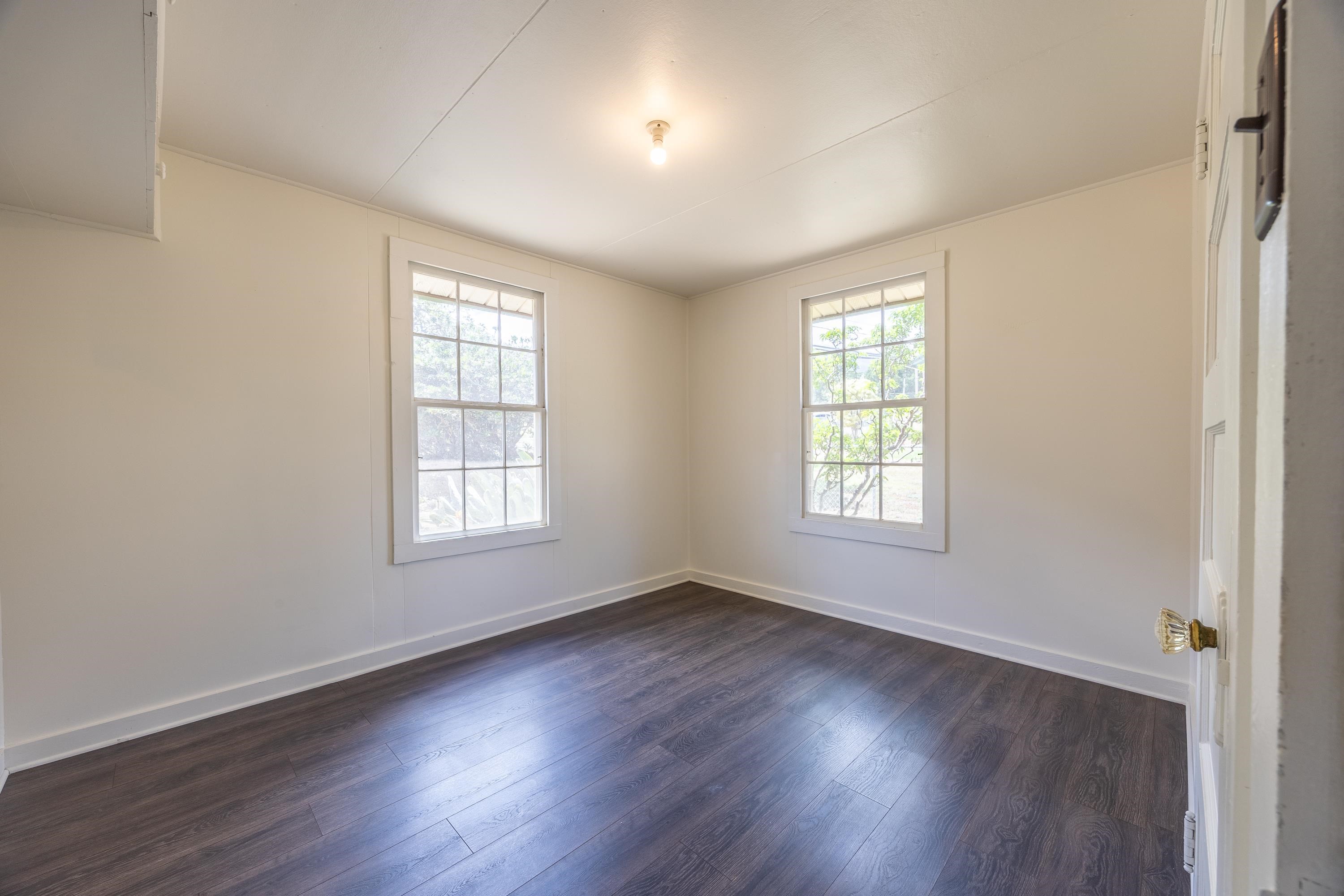 3044 Lower Kula Road Kula, HI 96790 - Photo 6 of 44 a view of an empty room with wooden floor and a window