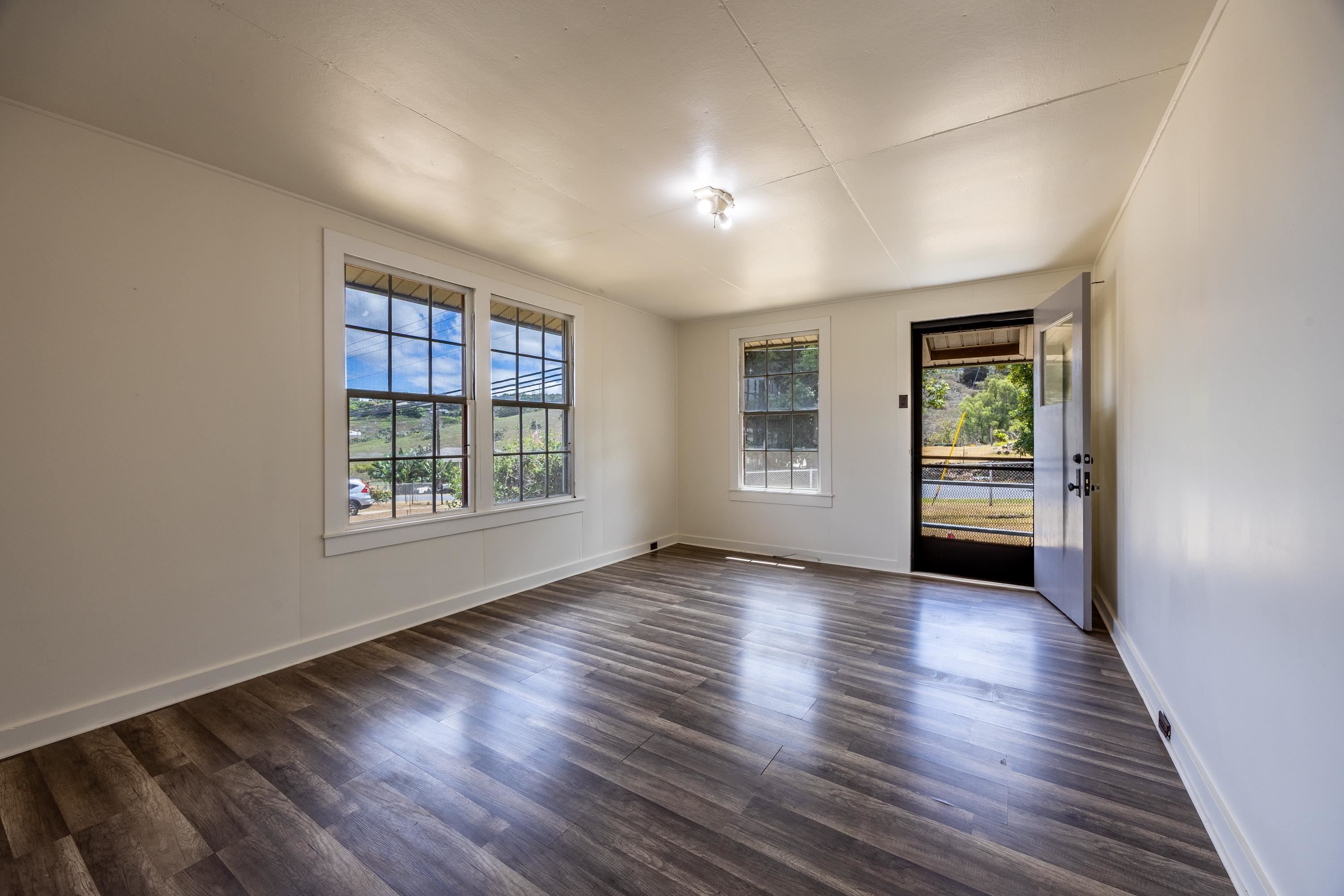 3044 Lower Kula Road Kula, HI 96790 - Photo 7 of 44 an empty room with wooden floor and windows