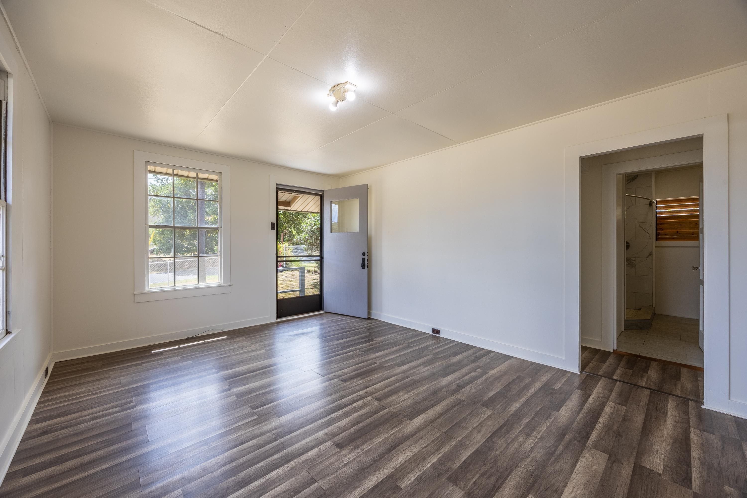3044 Lower Kula Road Kula, HI 96790 - Photo 8 of 44 a view of an empty room with wooden floor and a window