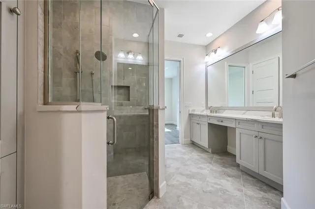 a bathroom with a shower sink and mirror