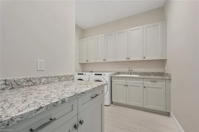 a view of a sink and cabinets