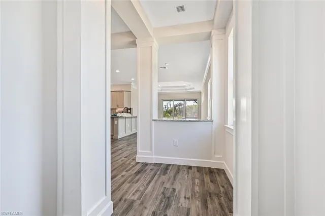 a view of hallway with wooden floor