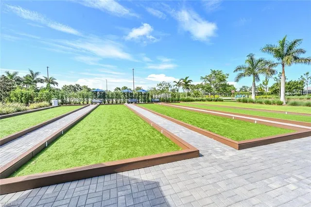 a view of a patio with couches table and chairs under an umbrella