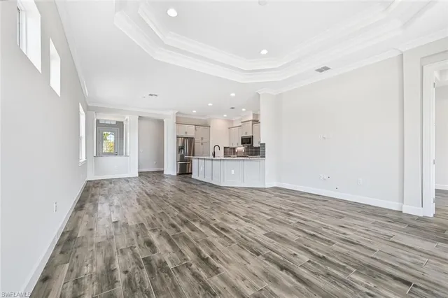 a view of a kitchen with wooden floor and kitchen space
