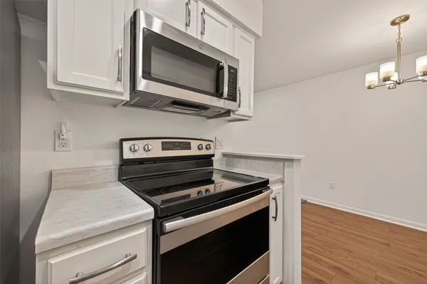 a kitchen with a stove and a microwave