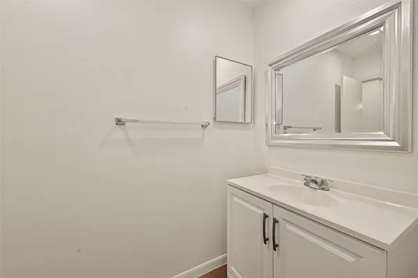 a bathroom with a sink and vanity