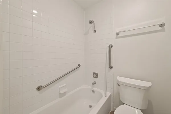 a white bath tub sitting next to a toilet