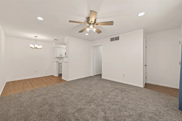 a view of empty room with ceiling fan