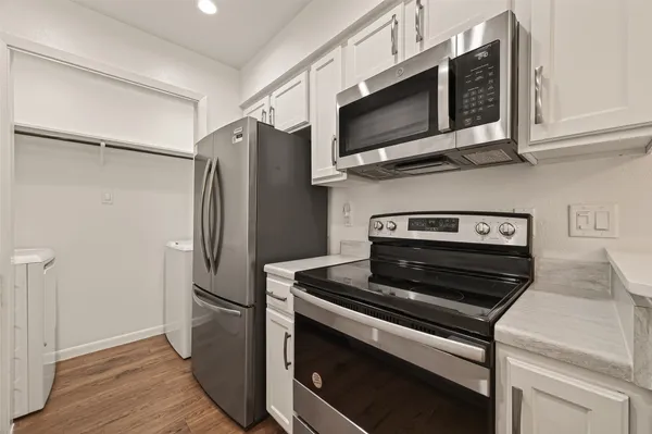 a kitchen with stainless steel appliances and wooden cabinets