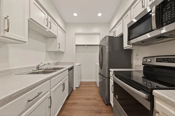 a kitchen with stainless steel appliances granite countertop a sink and a stove