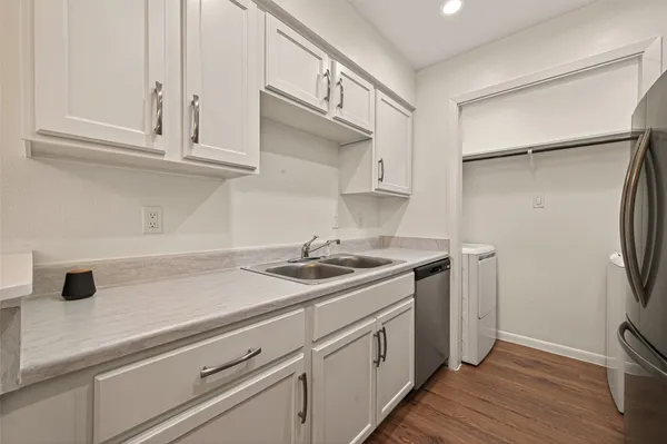a kitchen with stainless steel appliances white cabinets and a granite counter tops