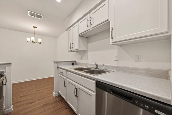 a kitchen with sink cabinets and wooden floor