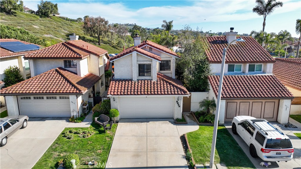3014 Enrique, Unit 98 San Clemente, CA 92673 - Photo 1 of 14 a front view of a house with a garden