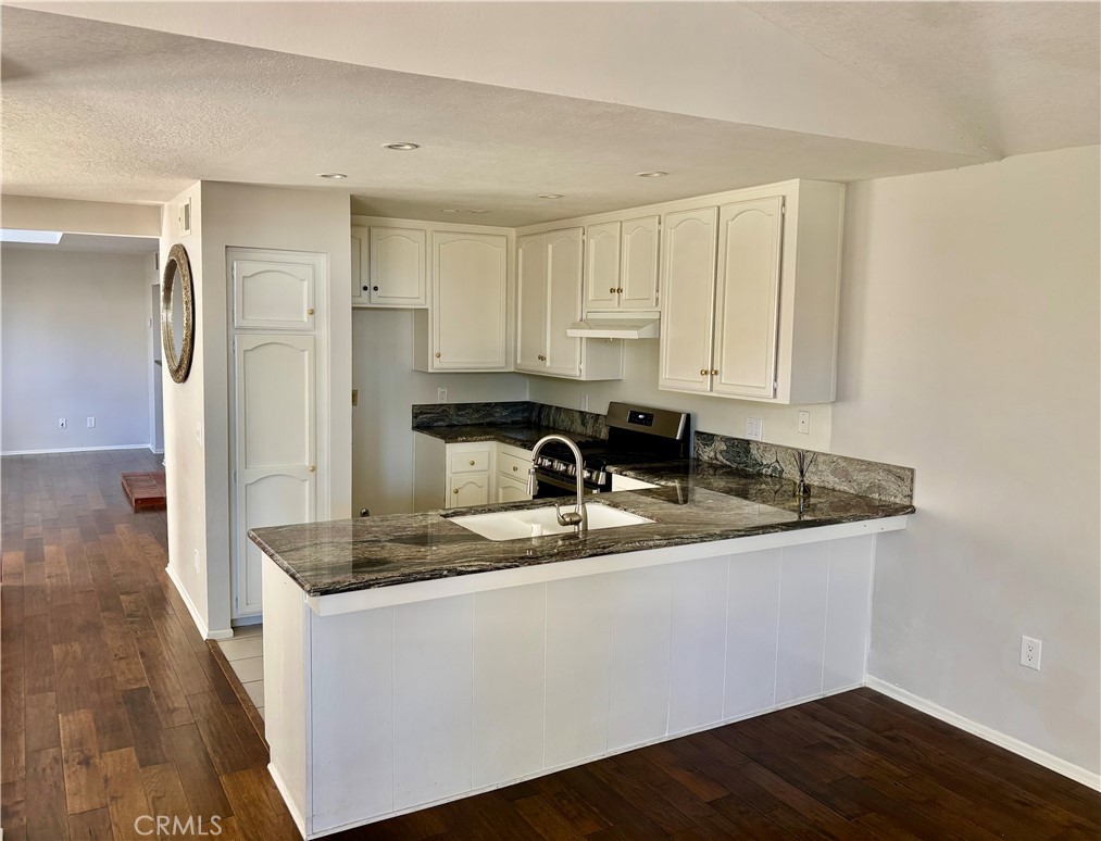 3014 Enrique, Unit 98 San Clemente, CA 92673 - Photo 4 of 14 a kitchen with stainless steel appliances granite countertop a sink and a refrigerator