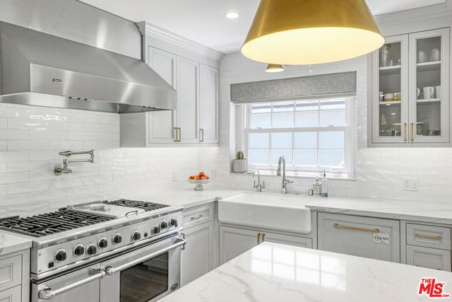 a kitchen with a sink stove and cabinets