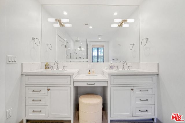 a bathroom with a sink vanity and a mirror