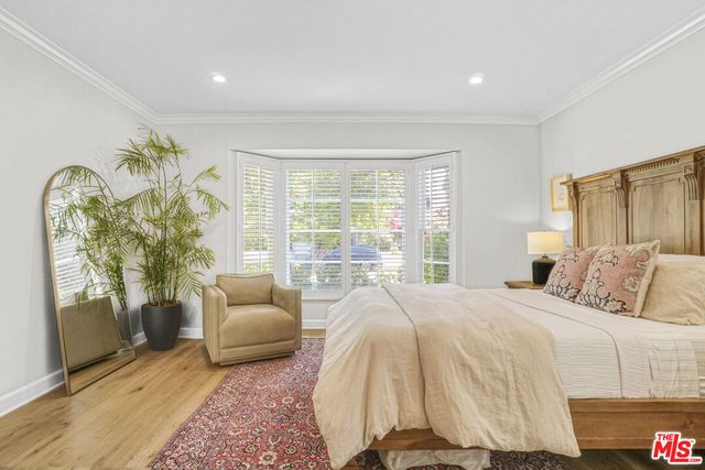 a spacious bedroom with a bed and glass window