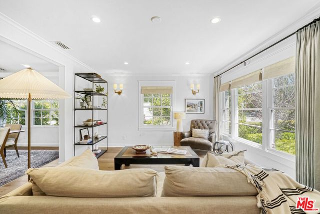 a living room with furniture and large windows