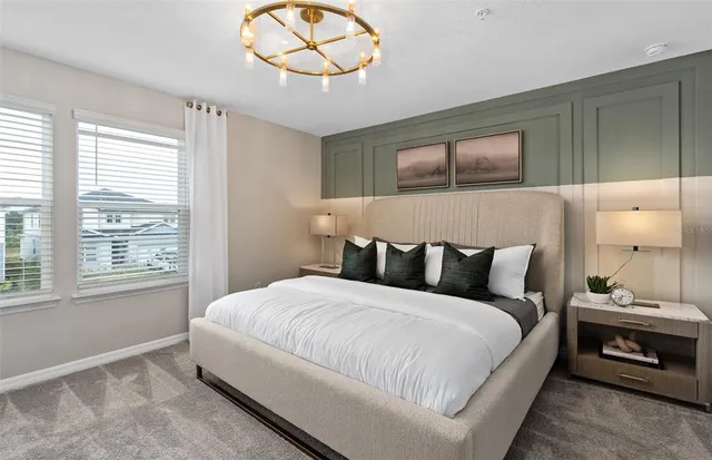 a bedroom with a bed and a chandelier