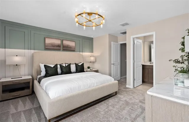 a bedroom with a bed and a chandelier