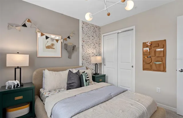 a bedroom with a bed and a lamp