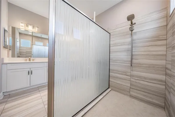 a bathroom with a shower and a sink