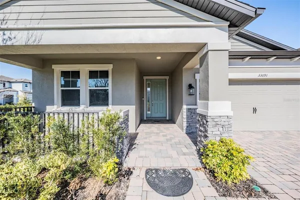 a front view of a house with a fountain