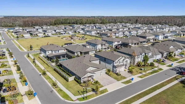 an aerial view of residential houses with outdoor space